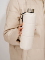 Glastrinkflasche kann ergänzt werden mit zahlreichen passenden Schutzhüllen aus faux-leather oder Filz. Schützt die Glasflasche auch für den Gebrauch unterwegs. Diese Glaswasserflasche kommt in einer weissen fluffigen Hülle in der Farbe off-white. Deckel in Edelstahl silber.